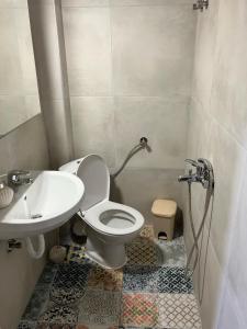 a bathroom with a toilet and a sink at The Family Place - Cosy Double bedroom apartment on beach of Kallithea, Chalkidiki in Kallithea Halkidikis