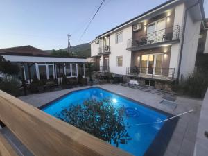 a swimming pool in front of a house at Villa Pegasus Pestani in Ohrid