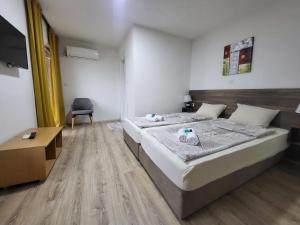 a bedroom with a bed and a desk and a chair at Villa Pegasus Pestani in Ohrid +30 photos