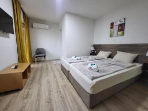 a bedroom with a bed and a desk and a chair at Villa Pegasus Pestani in Ohrid