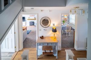 a room with a desk and a dining room at Birch Cottage in Northrepps