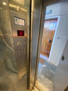 an elevator with a sign on the side of it at Seashore Happiness Apartments in Porto Rafti +31 photos
