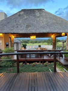 a pavilion with a picnic table and a roof at 7th Hole Golf Lodge in Modimolle