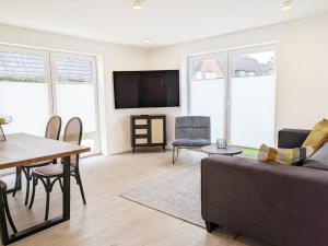 a living room with a couch and a table at Ferienwohnung Emilia in Garding