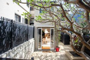 a house with a glass door and a fence at Chelsea Chic Paddington in Sydney