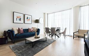 a living room with a blue couch and a table at Cosmopolitan Heights in Sydney