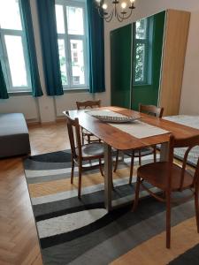 a dining room with a wooden table and chairs at Apartment Mariacki Tower in Krakow