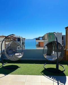 two wicker chairs sitting on top of a roof at Luxury Rooftop Vlora in Vlorë