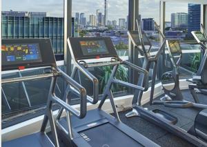 a gym with cardio machines and a view of the city at One Oak in Brisbane