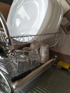 a plate and dishes in a dish rack in a sink at Elite stay in Embu