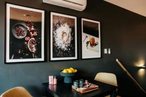 a dining room with a table and pictures on the wall at Midnight Moonshine Loft in Launceston