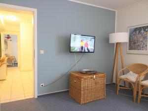 uma sala de estar com televisão na parede em Fernsicht-12b-EG em Wenningstedt