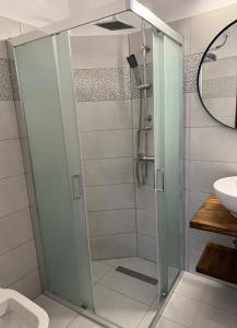 a shower with a glass door in a bathroom at Fedra Apartments Lindos in Líndos
