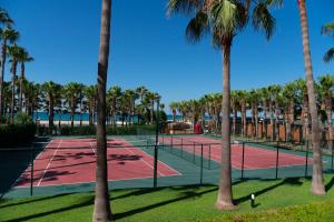 two tennis courts with palm trees in a park at Miramare Queen Hotel - Ultra All Inclusive in Side