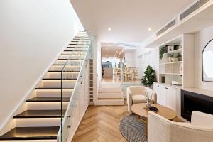 a staircase in a living room with a table and chairs at Royal Redfern Isyd in Sydney