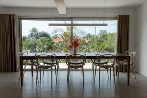a dining room table with chairs and a large window at GuestReady - A delightful stay in Porto Santo in Campo de Baixo