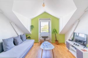 a living room with a couch and a table at Nid douillet au bord de l'erdre in Nantes