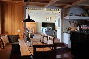 a dining room with a table and a living room at Fryksas Chalet in Fryksås