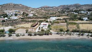 an aerial view of a house on a beach at Olea Suite Syros - Φοίνικας, Σύρος, Κυκλάδες in Posidhonía