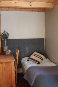 a bedroom with a bed and a wooden desk at Fryksas Chalet in Fryksås