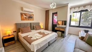 a bedroom with a large bed and a couch at Mykonut Boutique Suites in Fethiye +37 photos
