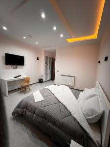 ein Schlafzimmer mit einem großen Bett und einem Schreibtisch in der Unterkunft Hotel Eloued فندق الوادي in Tiksebt