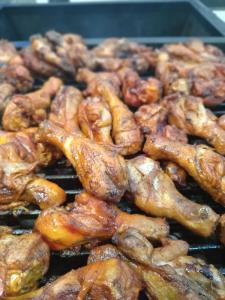 a bunch of chicken cooking on a grill at Queensland Hotel in Nuwara Eliya