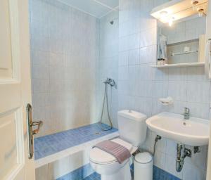 a bathroom with a toilet and a sink at Cycladic Ornos Apt Near Mykonos Town in Ornos