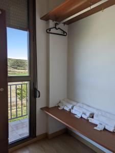 a room with a bench and a window at Albergue Valmadrid 
