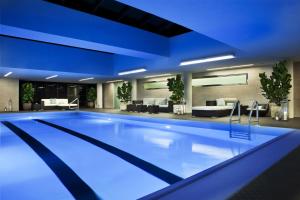 a swimming pool in a hotel with blue lighting at The Rittenhouse Hotel in Philadelphia