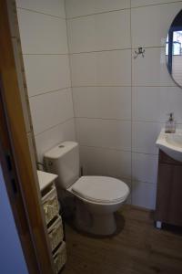 a bathroom with a toilet and a sink at Villa Rosa pokoje u Marzeny in Władysławowo