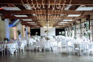 a banquet hall with white tables and chairs at Hôtel Quai des Pontis in Cognac