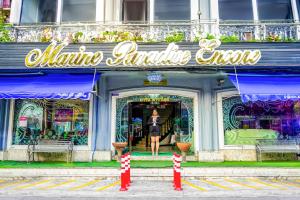 a woman standing in front of an entrance to an alina antigua group at Marine paradise Encore in Pattaya South