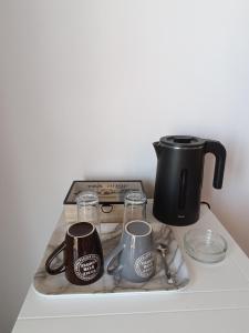 a counter with two coffee makers and a tea kettle at GOLDEN BEACH in Souvala