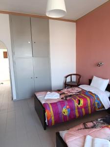 a bedroom with two beds and a cabinet at GOLDEN BEACH in Souvala
