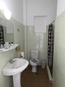a white bathroom with a sink and a toilet at GOLDEN BEACH in Souvala