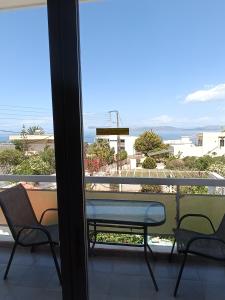 a bench on a balcony with a view of the ocean at GOLDEN BEACH in Souvala