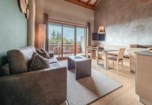 a living room with a couch and a table at Josef Mountain Resort in Avelengo