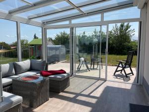 a living room with a couch and glass doors at Apartment Wachsenburgblick in Arnstadt