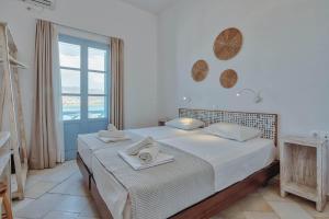 a bedroom with a bed with towels on it at Hotel Mantalena in Antiparos Town
