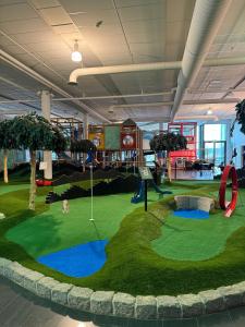 a playground in a building with a fake golf course at Quality Hotel Sarpsborg in Gralum