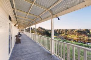 a balcony with a view of a river at Hopkins River Homestead in Allansford