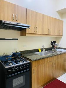 a kitchen with a stove and a sink at Hello condo in Manila