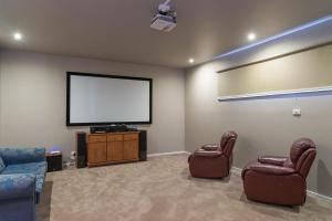 sala de estar con 2 sillas y TV de pantalla plana en Currawong Close Pool Pool Table Alfresco Featured, en Cowes