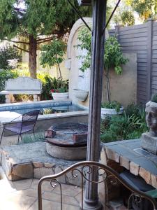 a patio with a fire pit and a table and chairs at A La Maison Boutique Guesthouse in Parys