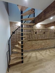 a staircase in a room with a brick wall at logement entier avec garage. in Rieux