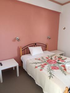 a bedroom with a bed with a white bedspread at GOLDEN BEACH in Souvala
