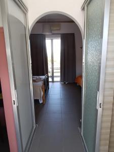 a hallway with an archway leading to a bedroom at GOLDEN BEACH in Souvala