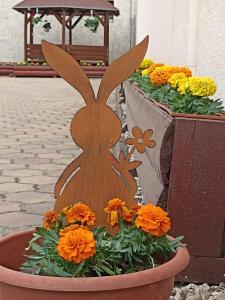 a planter with a wooden rabbit in a flower pot at Euro Panzio in Debrecen