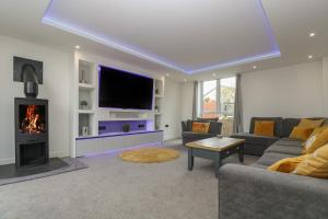 a living room with a couch and a fireplace at Valley View in Helston